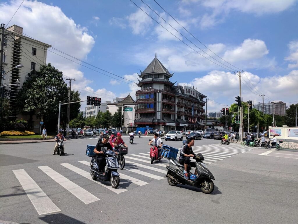 Scooters racing through an intersection in China
